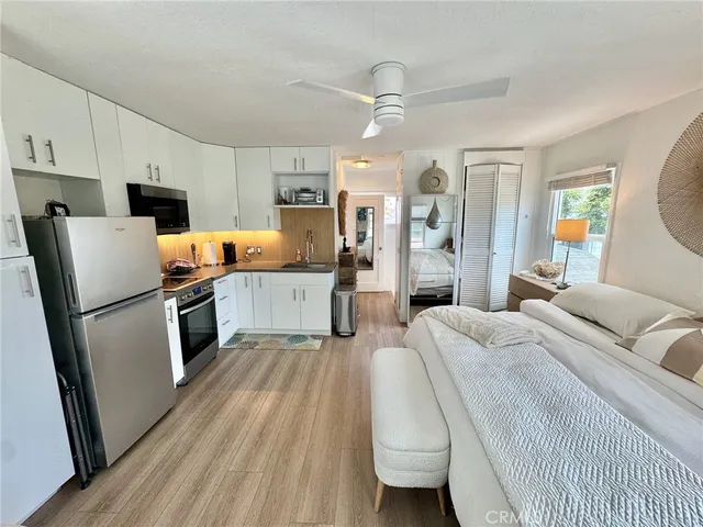 a kitchen with a refrigerator a stove and a sink
