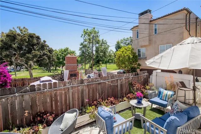 a view of a chairs and table in the back yard of the house