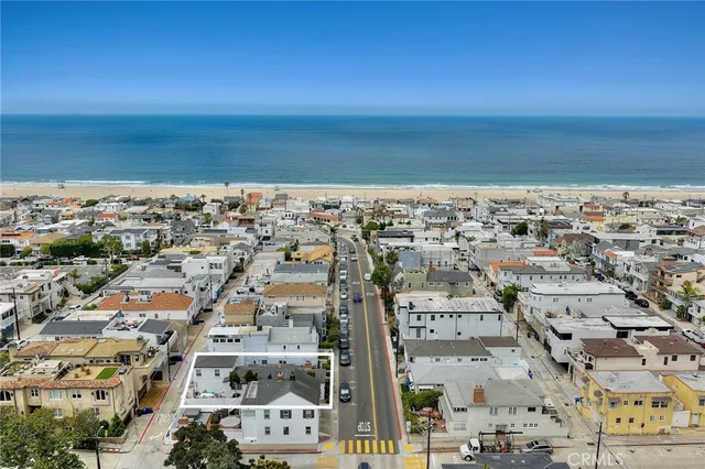 an aerial view of a city with ocean view