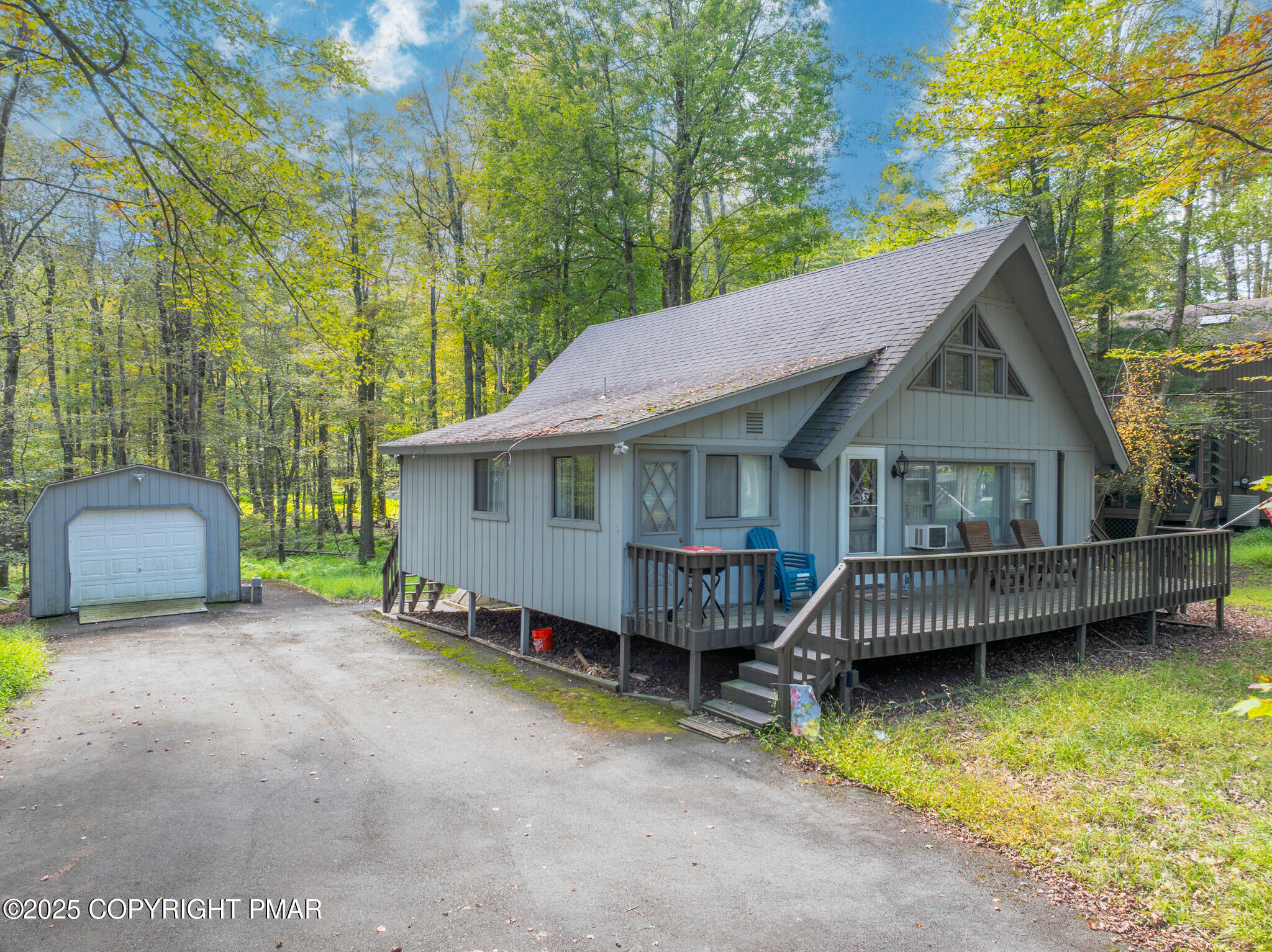 a view of house with swimming pool and a yard