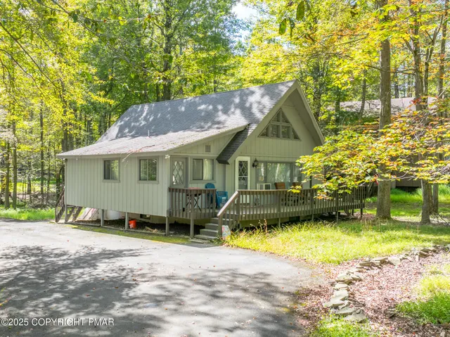 a front view of a house with a yard table and chairs