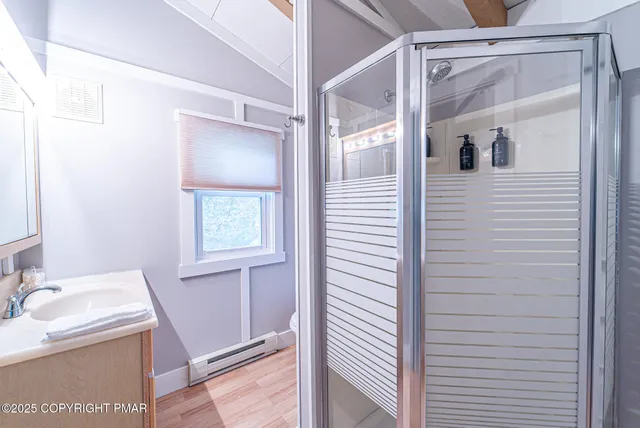 a bedroom with a bed and a lamp on the dresser