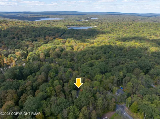 a sign that is sitting in the grass next to a building