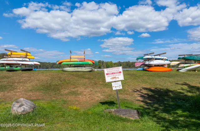 a view of a tennis ground with large trees
