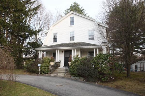 670 Boston Post Road Weston, MA 02493 - Photo 1 of 3 a view of a white house next to a yard with potted plants and trees
