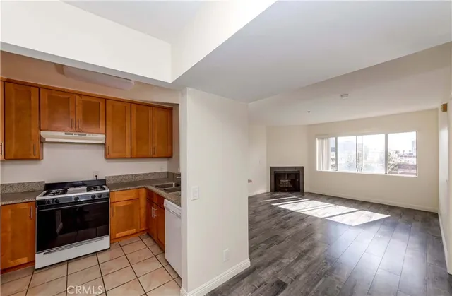 a kitchen with stainless steel appliances a stove a sink a microwave and cabinets