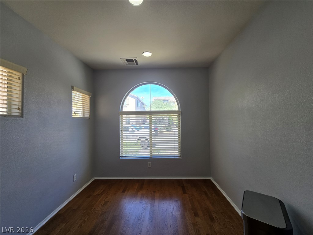 1049 Garnet Ridge Court Las Vegas, NV 89123 - Photo 14 of 39 Unfurnished room featuring a textured wall and dark wood-type flooring