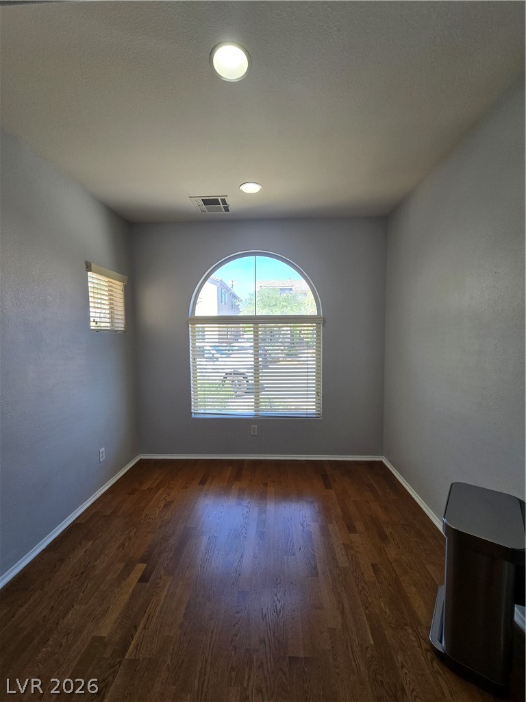 1049 Garnet Ridge Court Las Vegas, NV 89123 - Photo 15 of 39 Spare room with dark wood-type flooring, healthy amount of natural light, and recessed lighting
