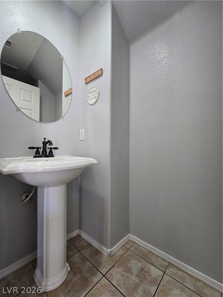 1049 Garnet Ridge Court Las Vegas, NV 89123 - Photo 17 of 39 Bathroom featuring a textured wall and light tile patterned floors