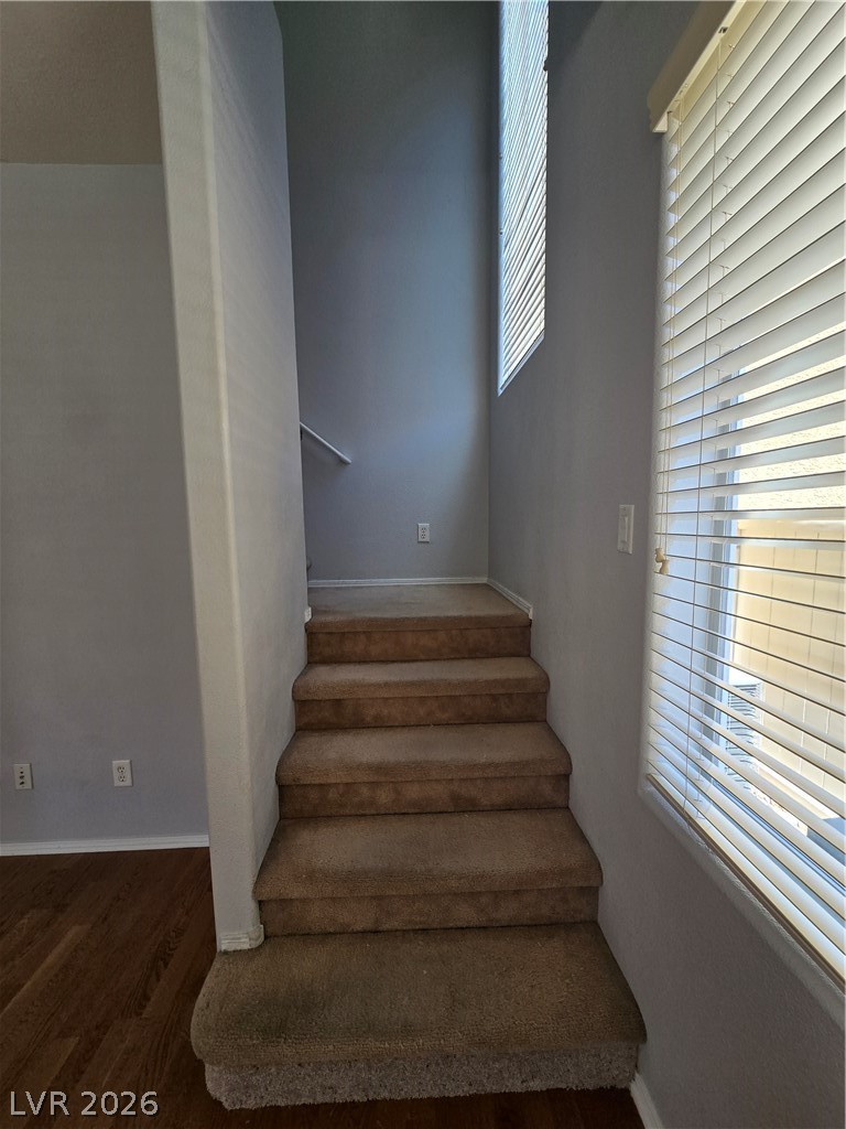 1049 Garnet Ridge Court Las Vegas, NV 89123 - Photo 18 of 39 Stairway featuring baseboards and wood finished floors