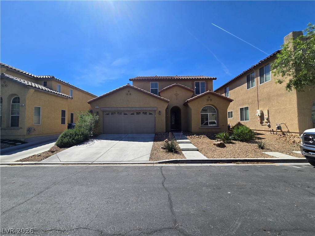 1049 Garnet Ridge Court Las Vegas, NV 89123 - Photo 2 of 39 Mediterranean / spanish home with stucco siding, a garage, and driveway