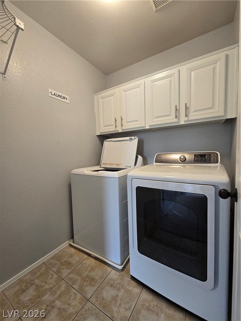 1049 Garnet Ridge Court Las Vegas, NV 89123 - Photo 22 of 39 Laundry room with cabinet space, washing machine and dryer, and light tile patterned floors