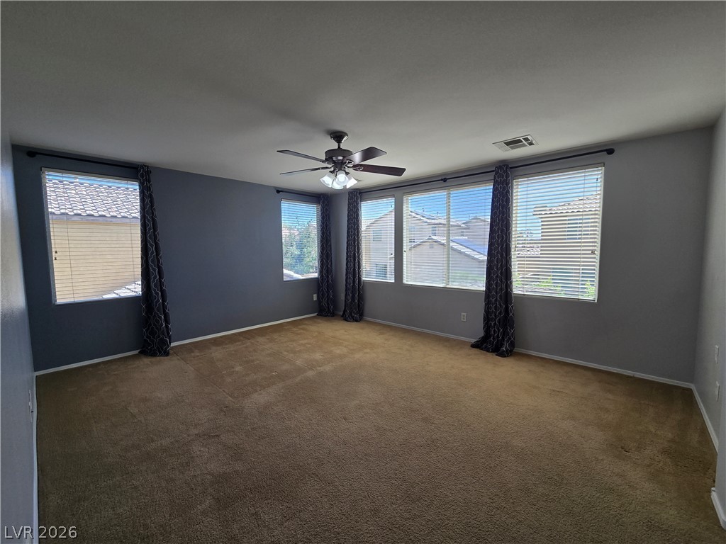 1049 Garnet Ridge Court Las Vegas, NV 89123 - Photo 24 of 39 Spare room with a ceiling fan and dark colored carpet