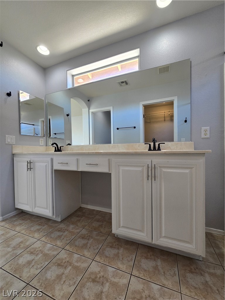 1049 Garnet Ridge Court Las Vegas, NV 89123 - Photo 27 of 39 Bathroom with double vanity and light tile patterned flooring