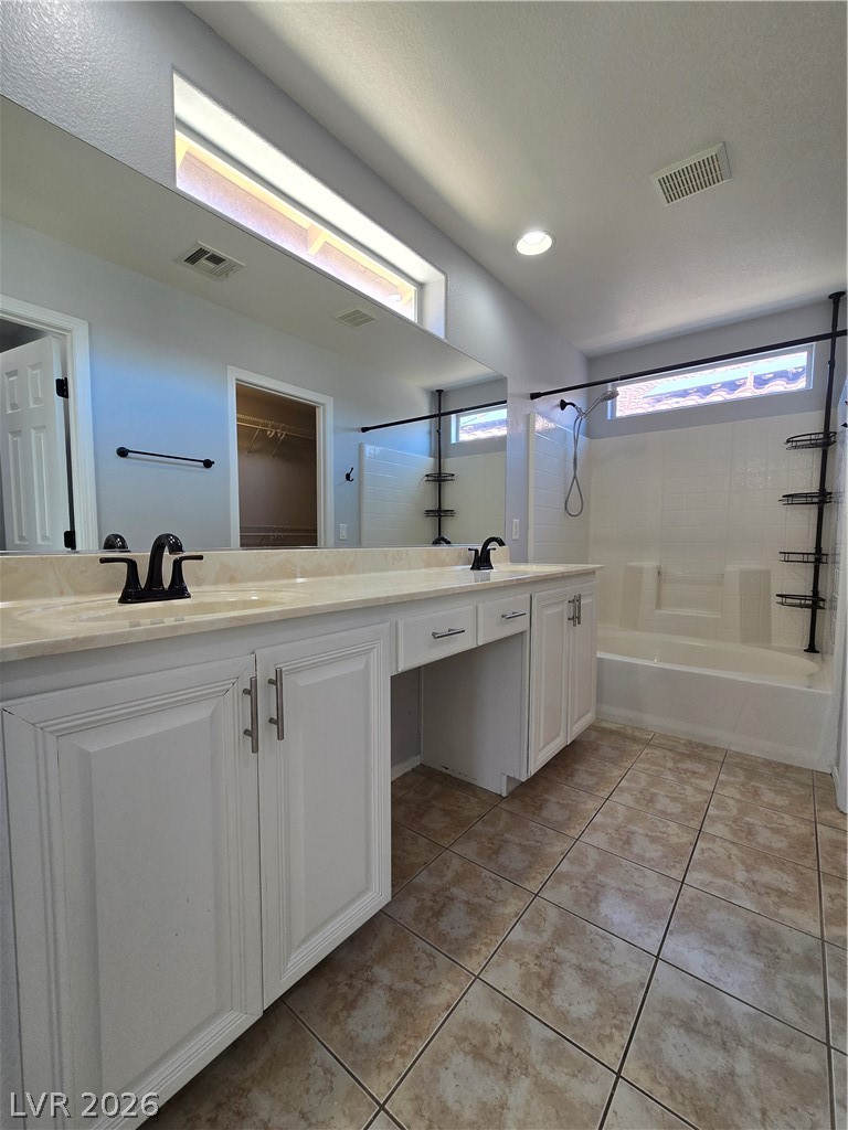 1049 Garnet Ridge Court Las Vegas, NV 89123 - Photo 28 of 39 Bathroom featuring double vanity, shower / bathtub combination, and light tile patterned flooring