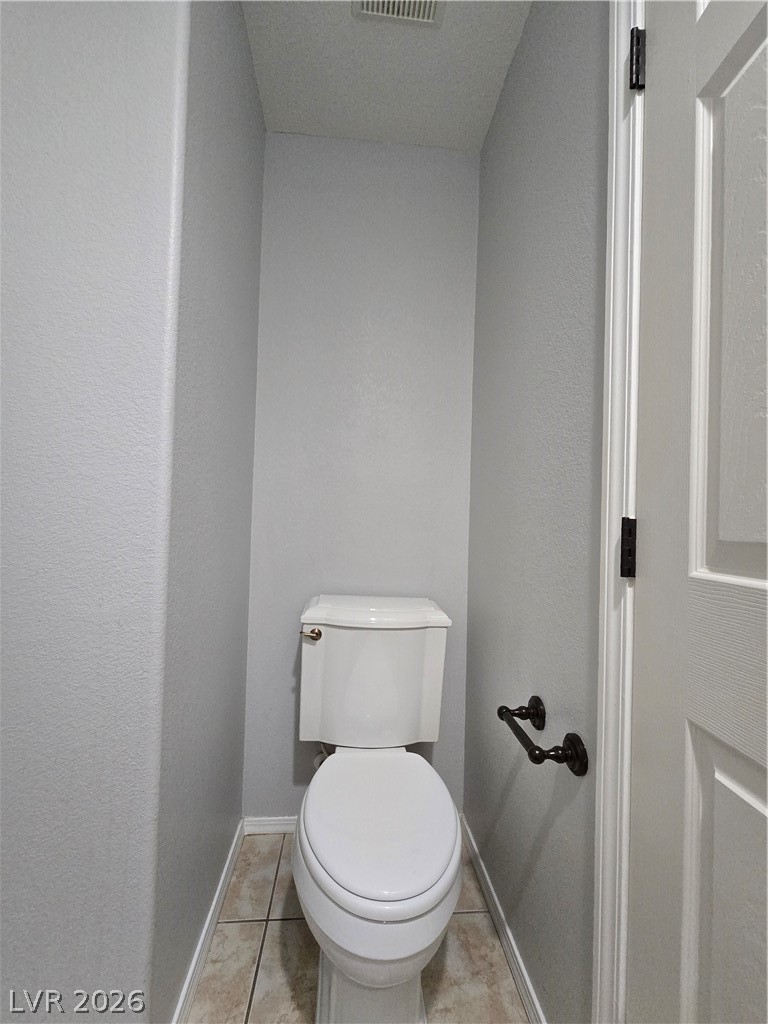1049 Garnet Ridge Court Las Vegas, NV 89123 - Photo 29 of 39 Bathroom featuring toilet and light tile patterned flooring
