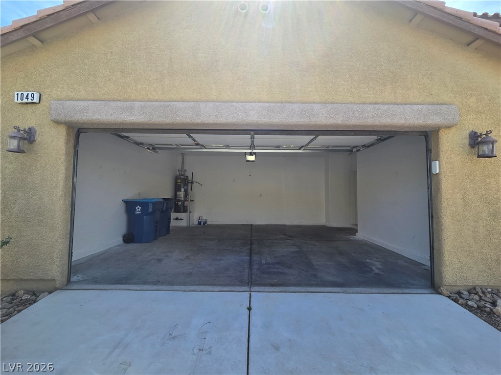 1049 Garnet Ridge Court Las Vegas, NV 89123 - Photo 3 of 39 Garage featuring driveway and water heater