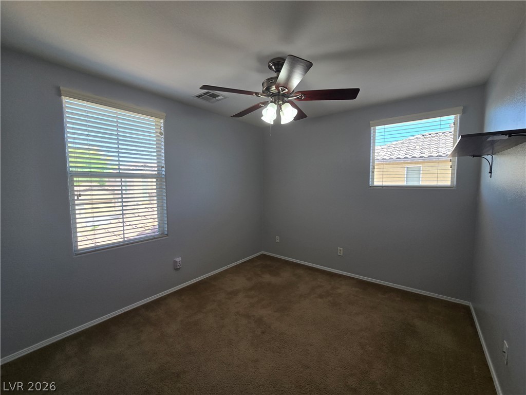 1049 Garnet Ridge Court Las Vegas, NV 89123 - Photo 31 of 39 Spare room with a ceiling fan and dark carpet