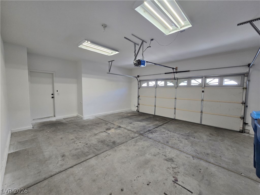 1049 Garnet Ridge Court Las Vegas, NV 89123 - Photo 36 of 39 Garage with baseboards and a garage door opener