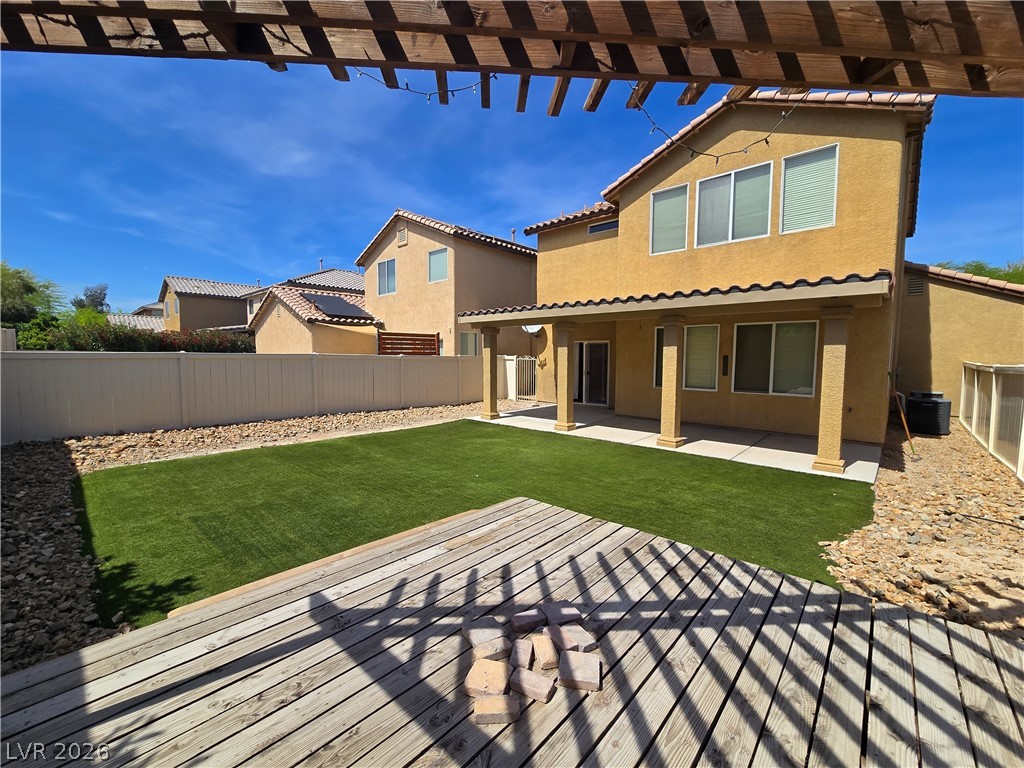 1049 Garnet Ridge Court Las Vegas, NV 89123 - Photo 39 of 39 Rear view of house with a pergola, stucco siding, a patio, a fenced backyard, and a tiled roof