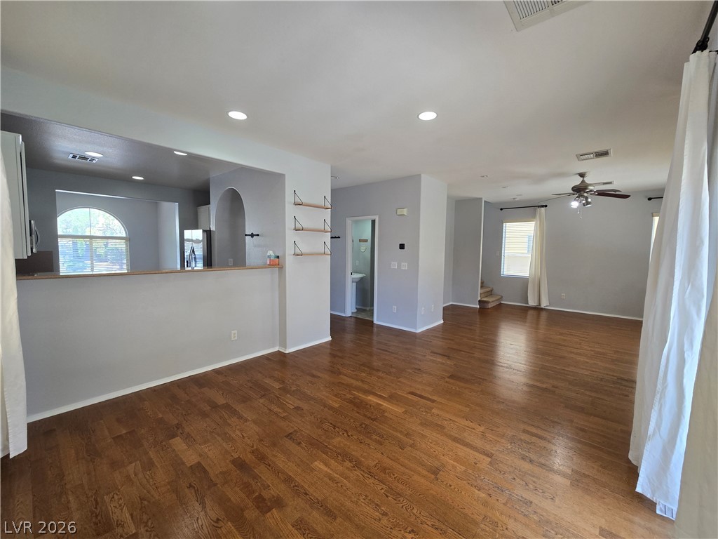 1049 Garnet Ridge Court Las Vegas, NV 89123 - Photo 5 of 39 Unfurnished living room with dark wood finished floors, recessed lighting, plenty of natural light, and ceiling fan