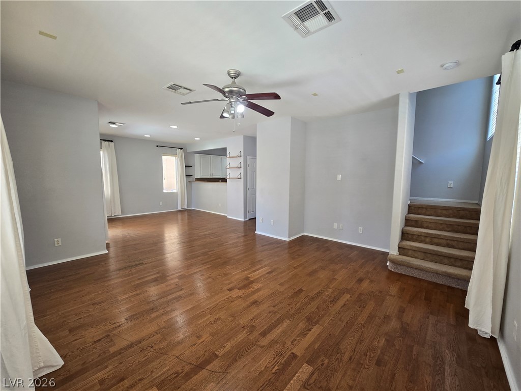 1049 Garnet Ridge Court Las Vegas, NV 89123 - Photo 6 of 39 Unfurnished living room featuring dark wood finished floors and ceiling fan