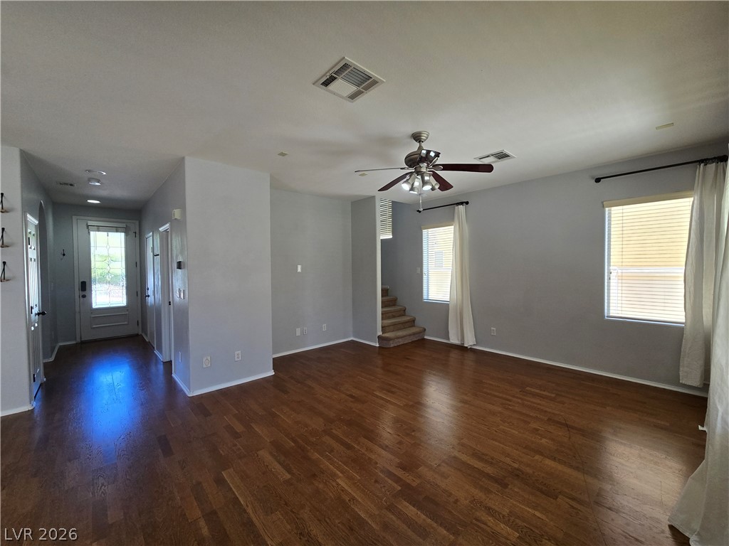 1049 Garnet Ridge Court Las Vegas, NV 89123 - Photo 7 of 39 Unfurnished living room featuring dark wood-style flooring and a ceiling fan