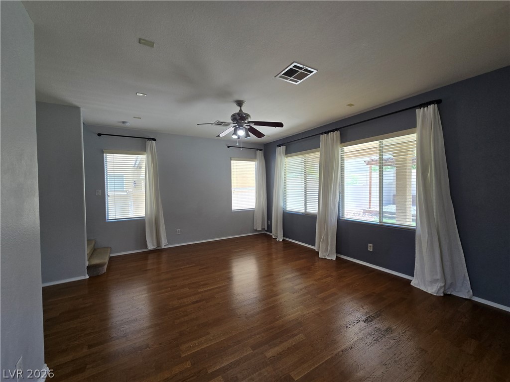 1049 Garnet Ridge Court Las Vegas, NV 89123 - Photo 9 of 39 Unfurnished room with dark wood finished floors and a ceiling fan