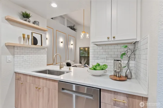 a kitchen with stainless steel appliances kitchen island a table and chairs in it