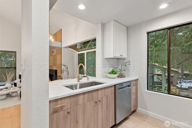 a kitchen with a sink and large window