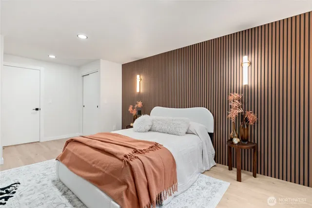 a bedroom with a bed and a night stand