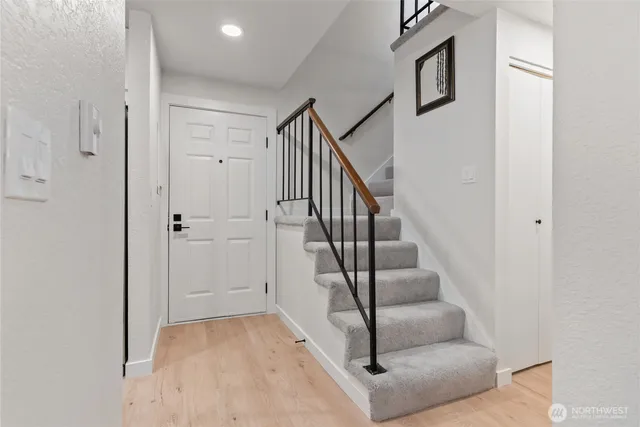 a view of entryway and hall with wooden floor