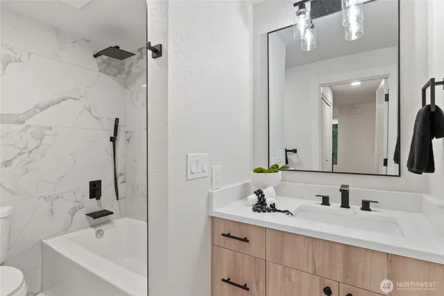 a bathroom with a double vanity sink and a mirror