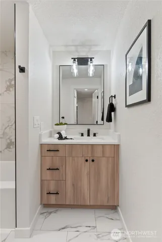 a en suite bathroom with a double vanity sink a mirror and a shower
