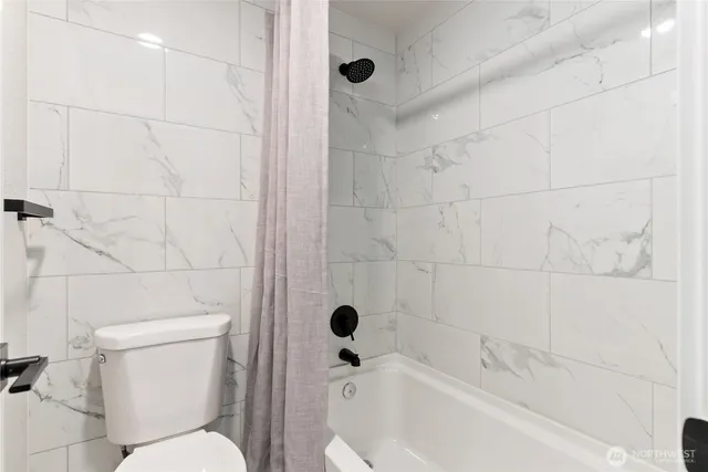 a bedroom with a bed lamp and a potted plant