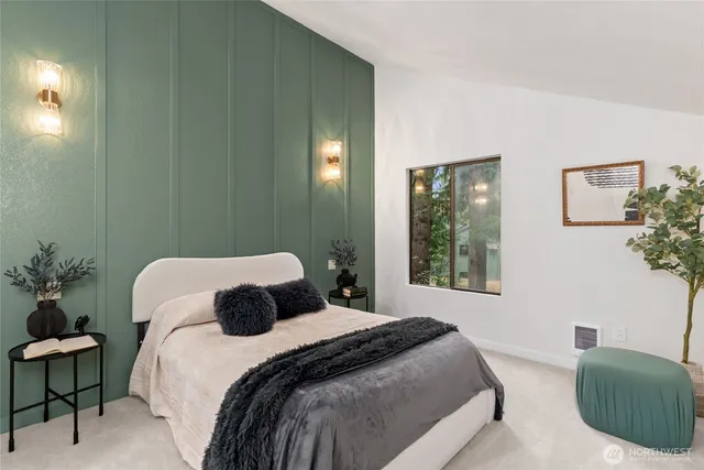 a bedroom with a bed and a lamp