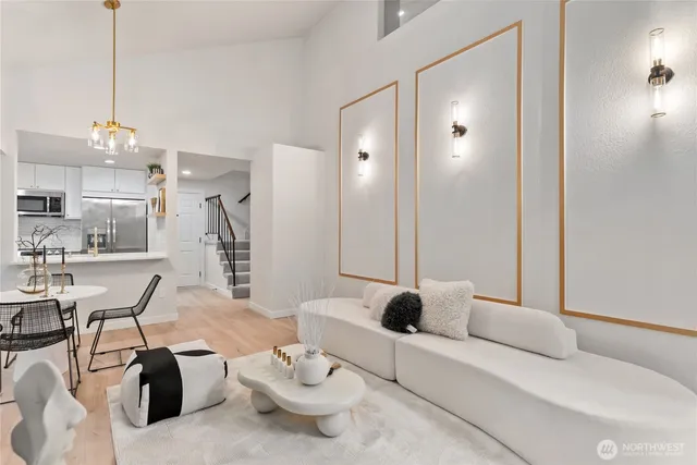 a living room with furniture and a chandelier