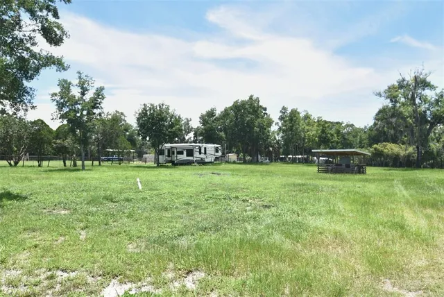 a view of green field in front of a house