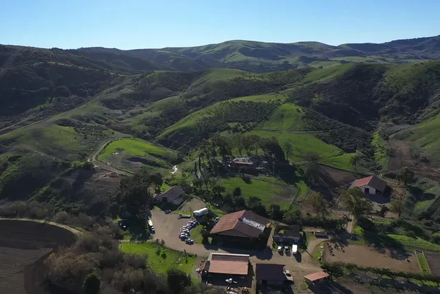 an aerial view of residential house with green space