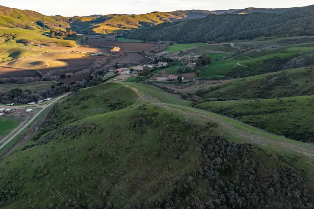 a view of a lush green hillside and lots of green space