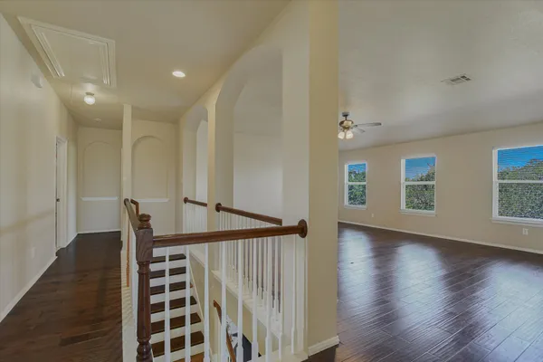 a view of entryway with wooden floor and stairs