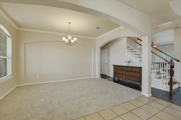 a view of an empty room with wooden floor fireplace and a window