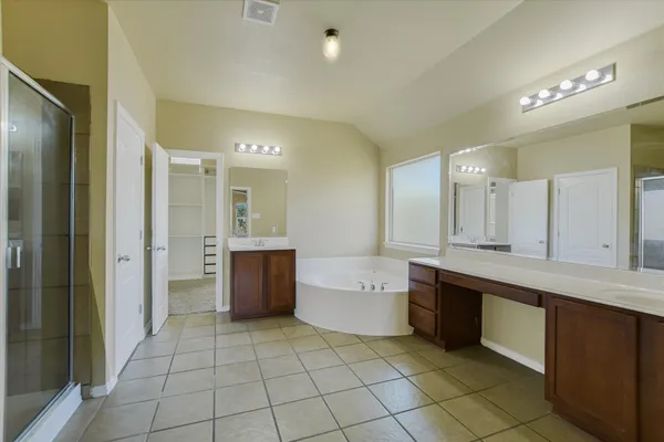 a large residential kitchen with a sink and cabinets