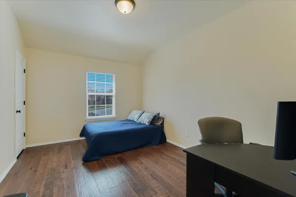 a bedroom with a workspace