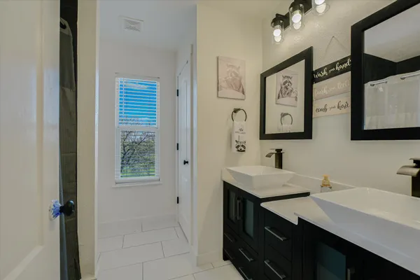 a bathroom with a sink vanity and a mirror