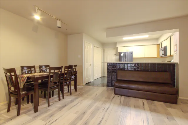 a view of a dining room with furniture and wooden floor