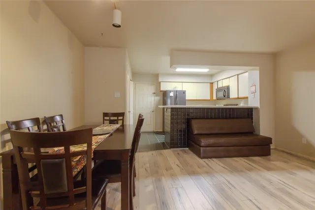 a view of a dining room with furniture and wooden floor