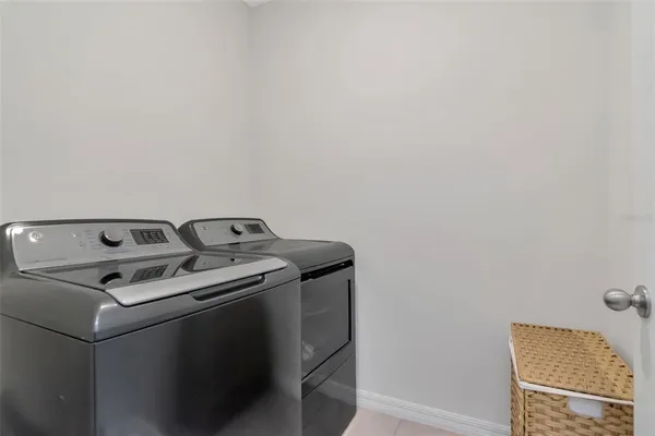 a close up of a utility room with dryer and washer