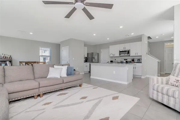 a living room with furniture and kitchen view