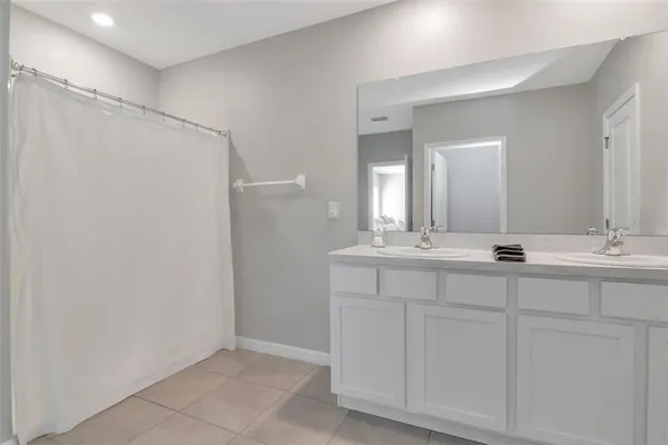 a bathroom with 2 sink and a mirror